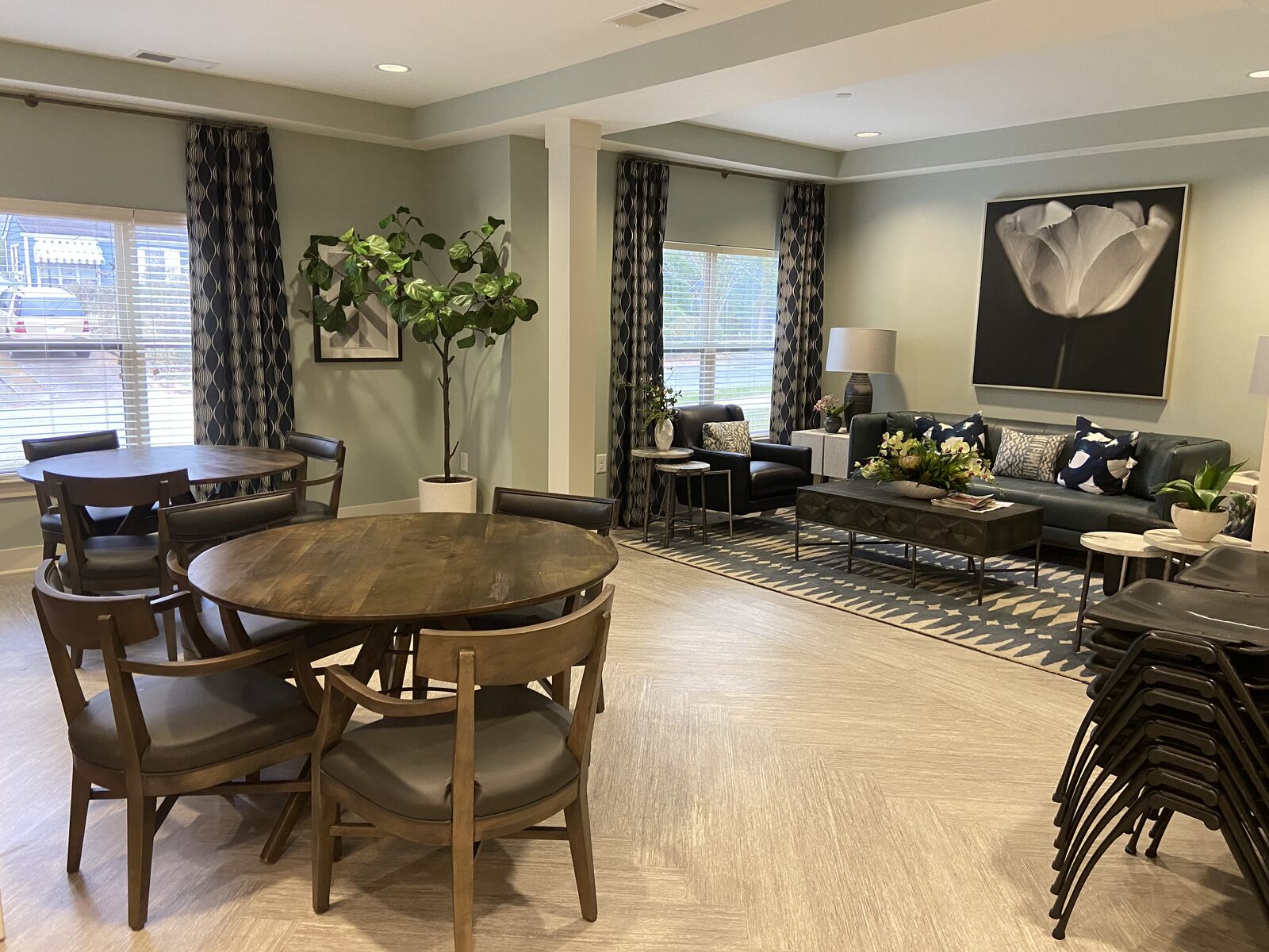 Furnished community room with round dining table and lounge seating