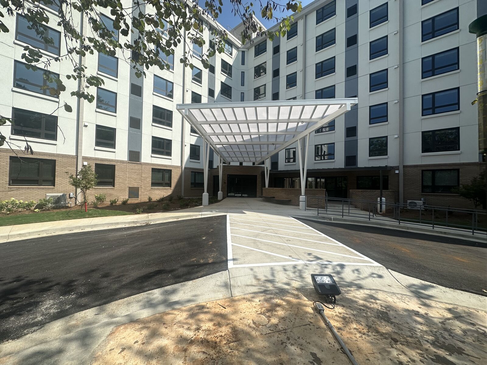 Multi-story apartment building with covered entry canopy