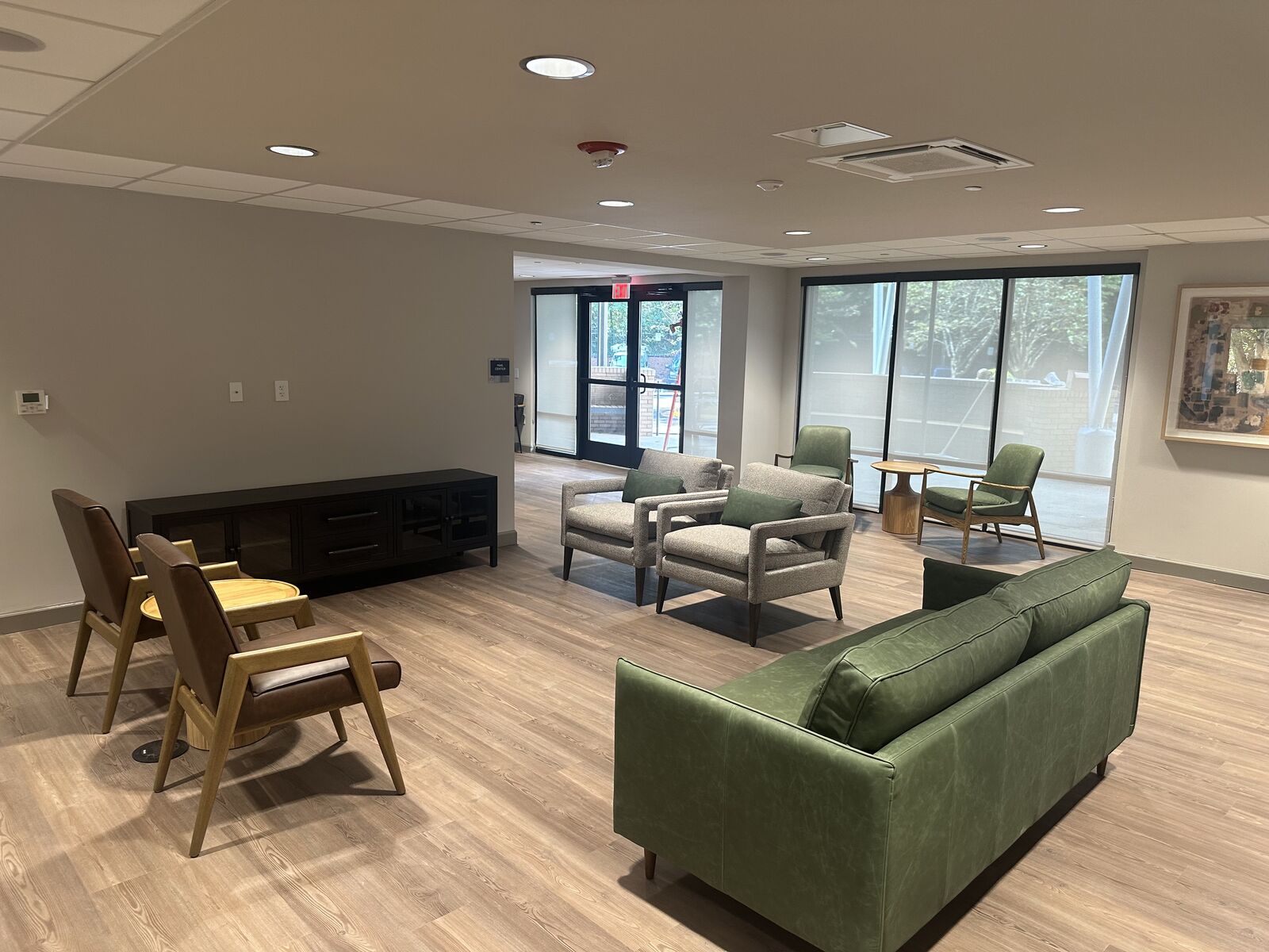 Community lounge with seating groups and large windows